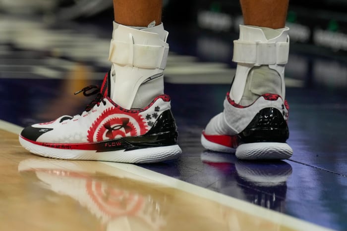 Stephen Curry's white, red, and black shoes.